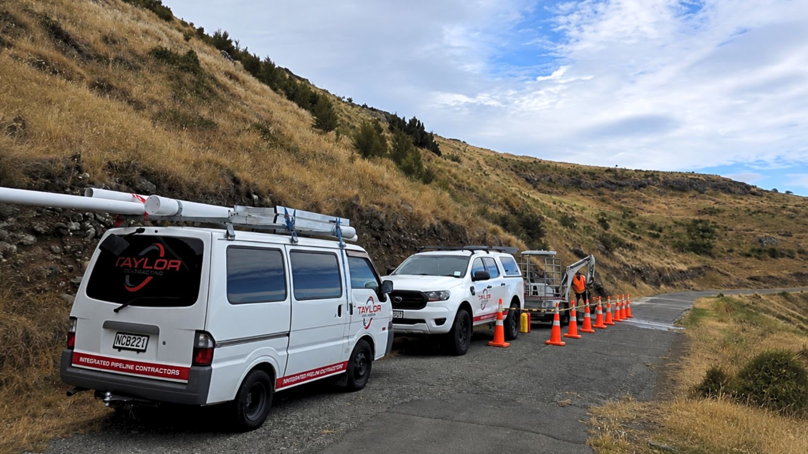 Taylor Plumbing van, ute and mini excavator on a Hamilton job site