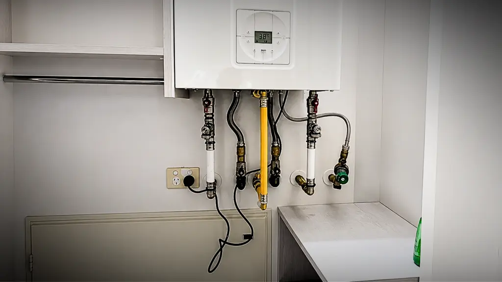 Commercial plumber servicing pipework in a Hamilton business premises