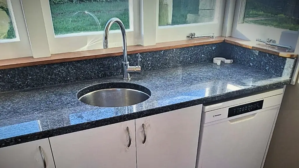 Plumber connecting the water supply for a new dishwasher in Hamilton