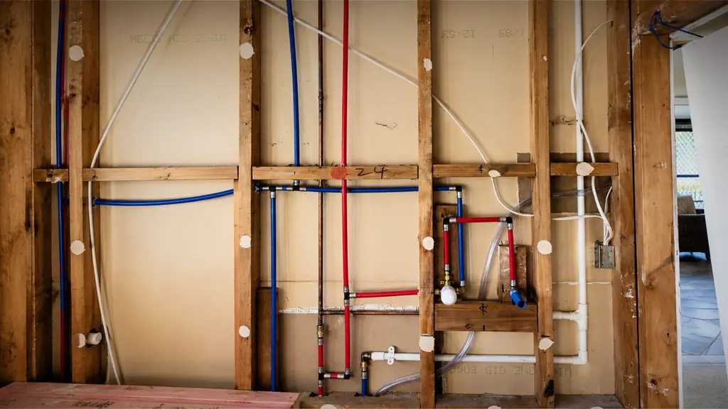 Old galvanised pipes being replaced with new plumbing in a Hamilton home