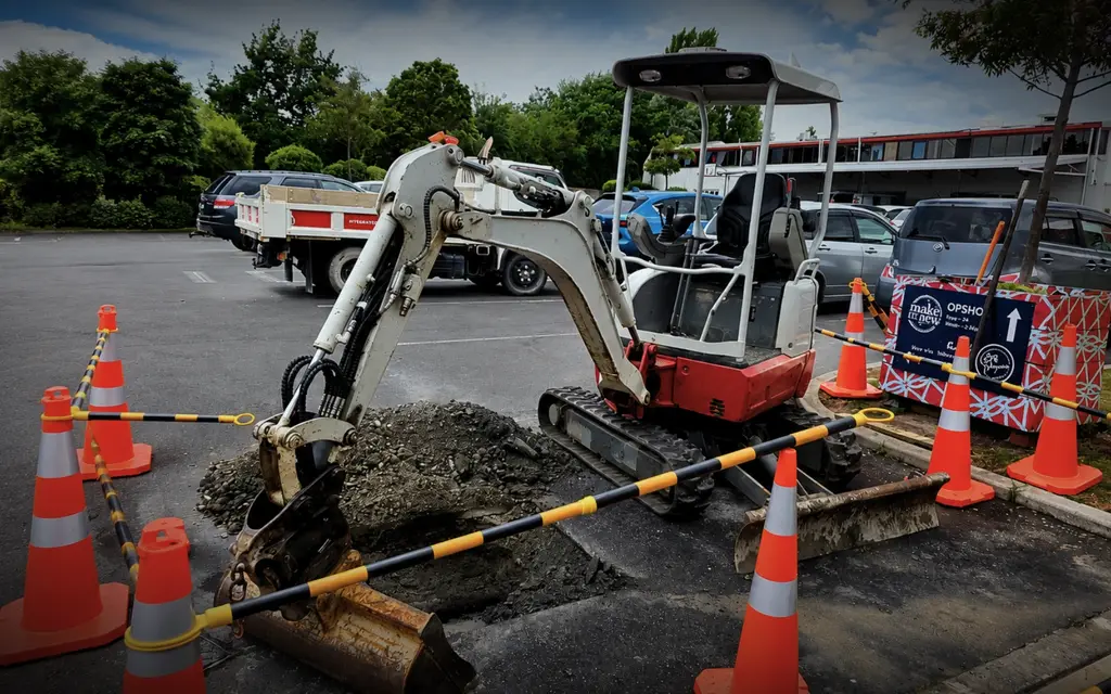Plumber working on washroom plumbing at a Hamilton school